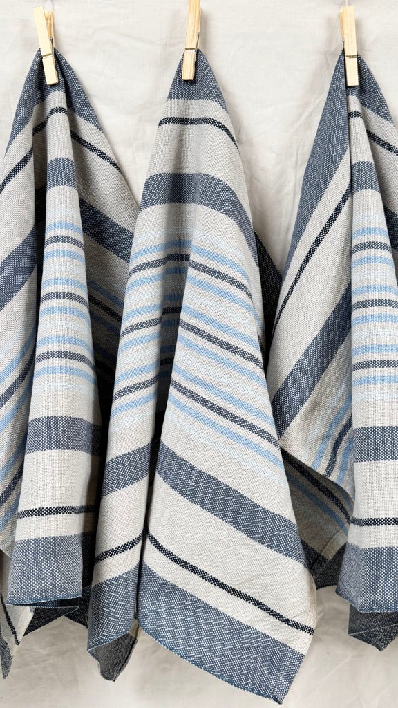 three hanging grey and blue striped towels