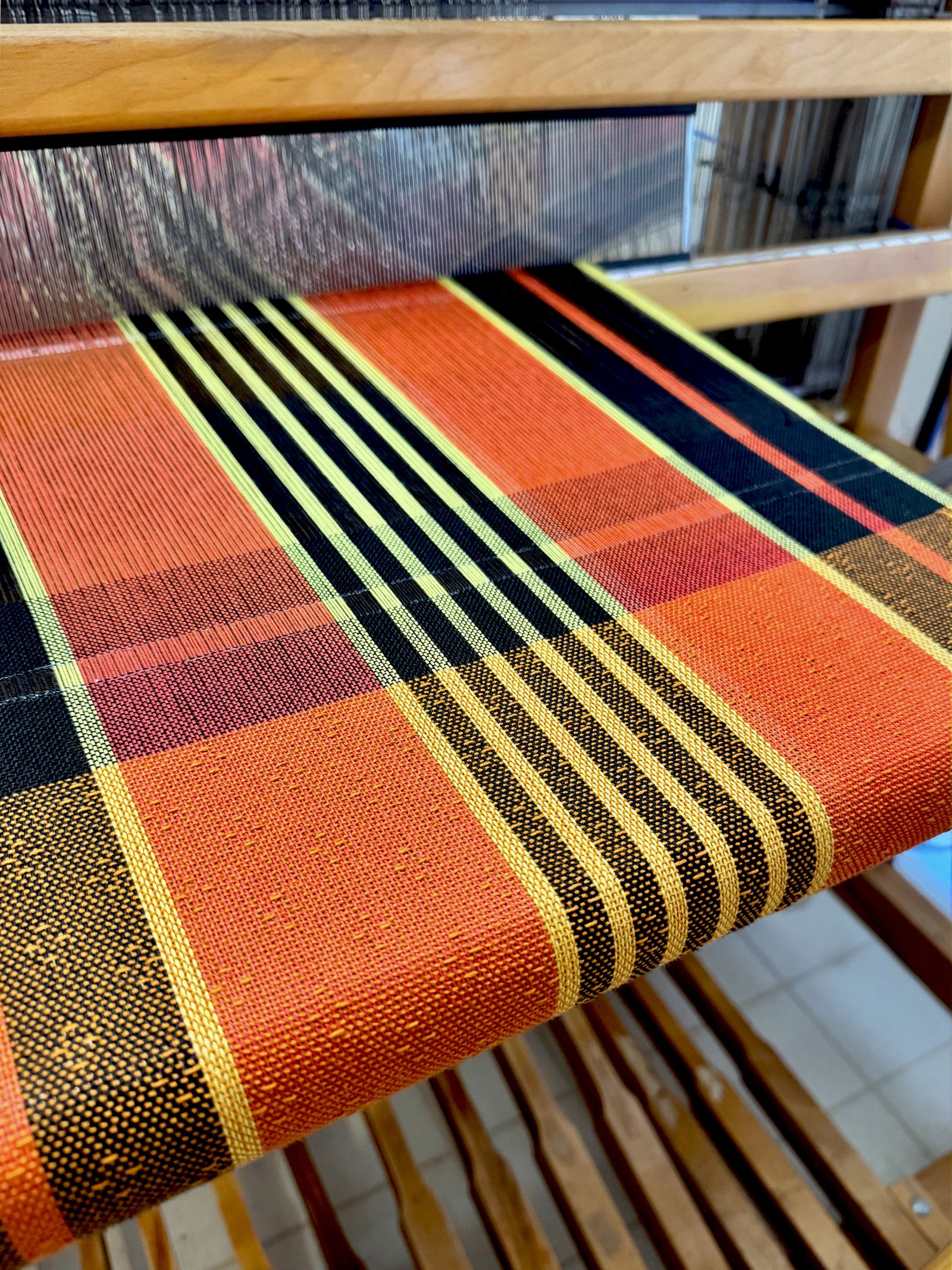 striped halloween tea towel on a floor loom