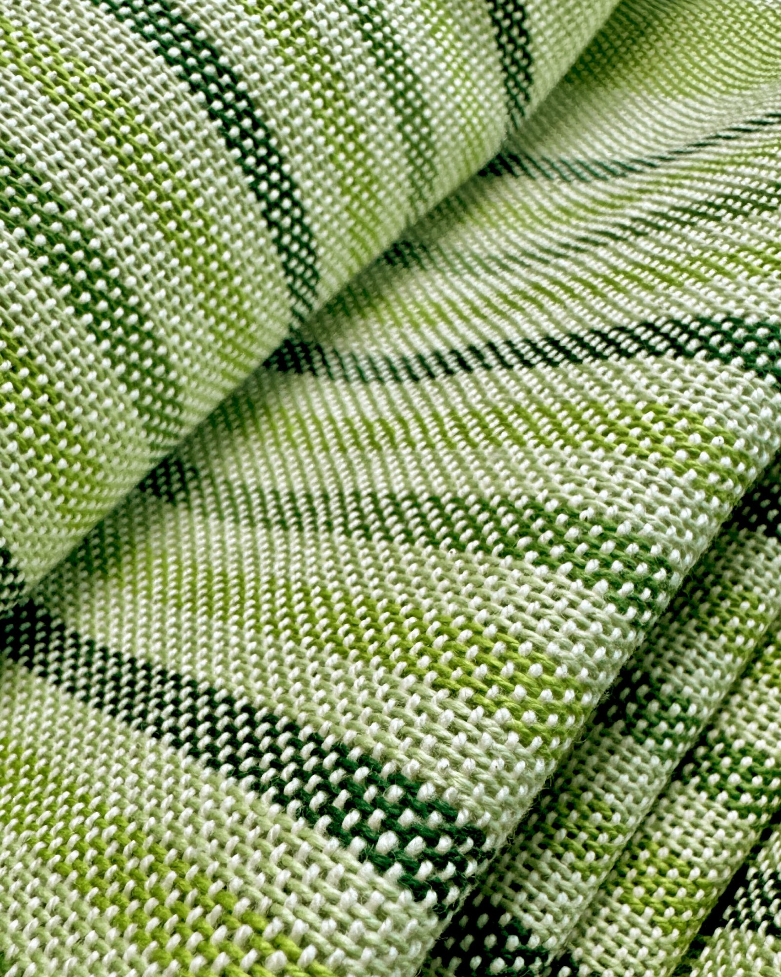 close up of a folded green striped towel
