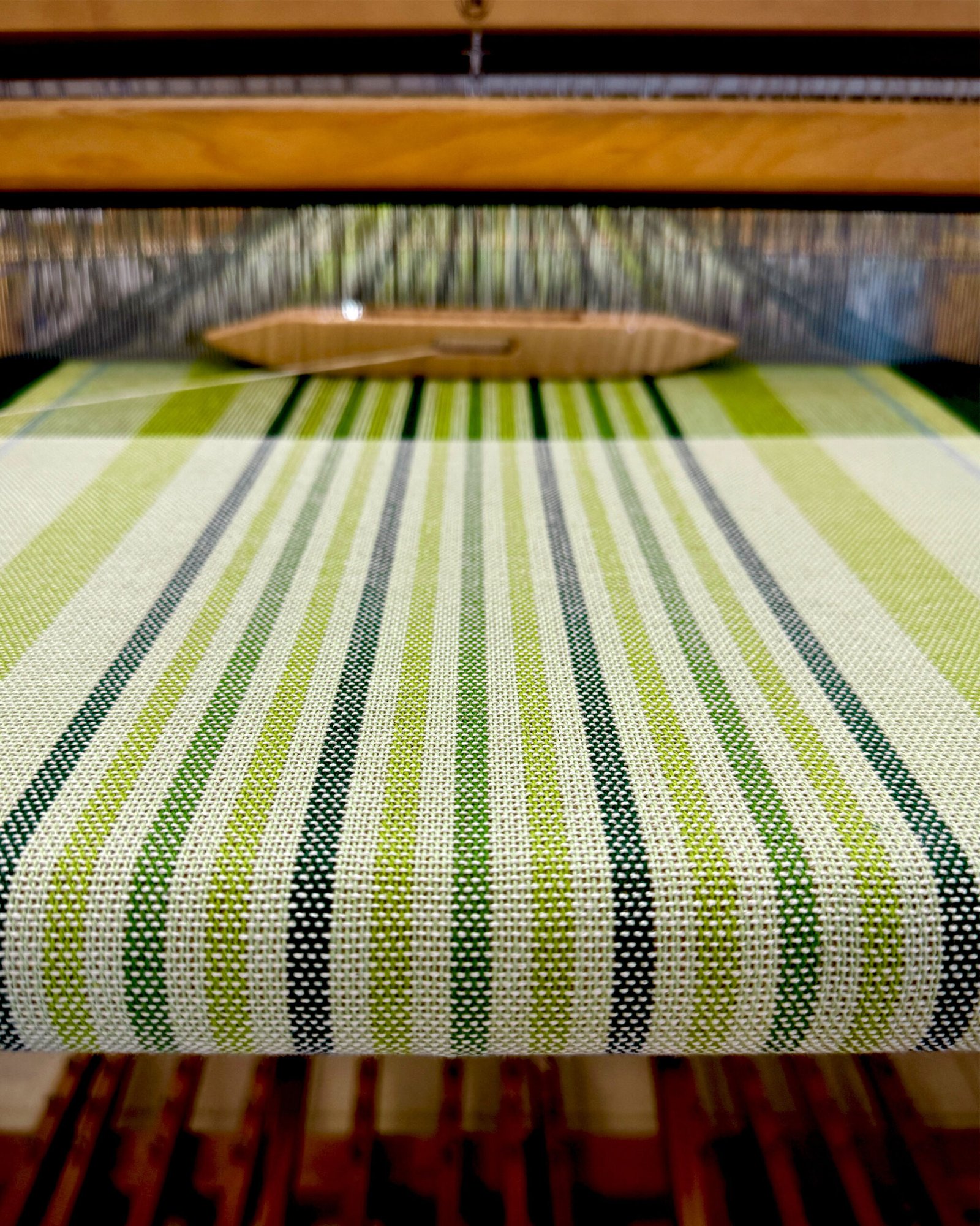 green striped towel on a floor loom