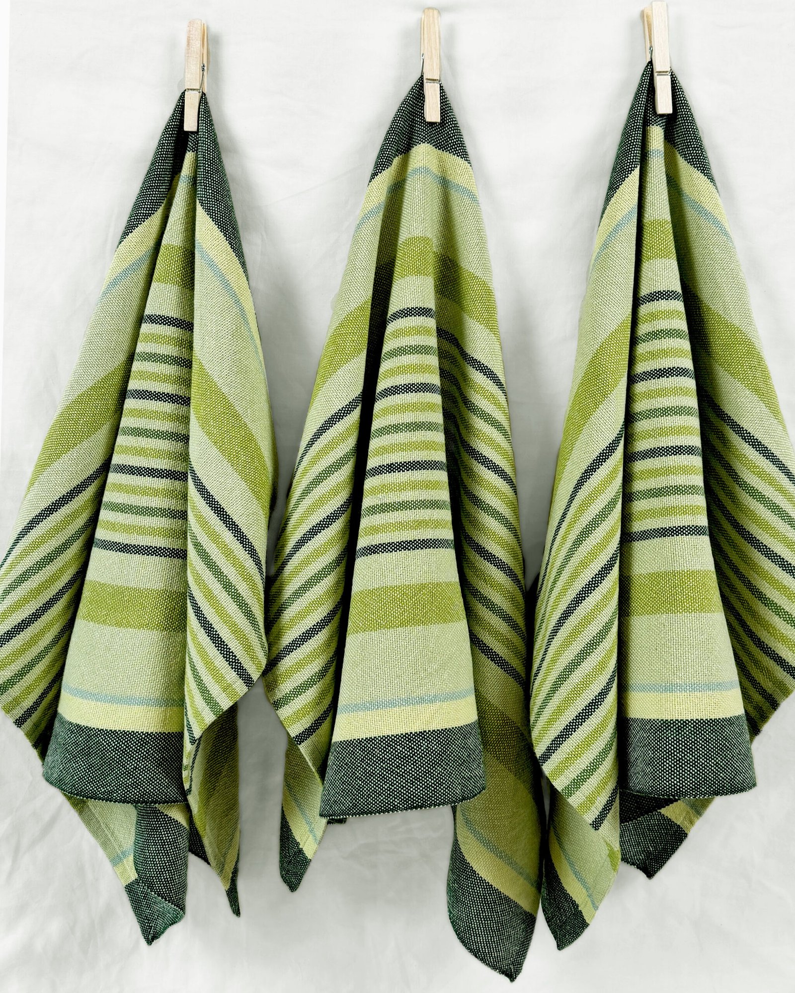 three hanging striped green towels